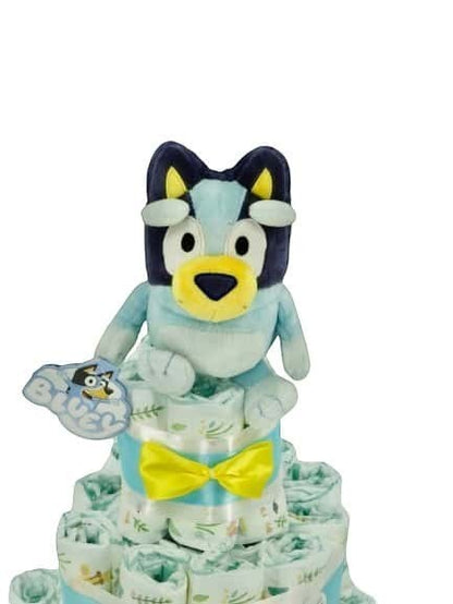 Tarta de pañales MomentosGourmet con peluche de Bluey, decorada con lazo amarillo y pañales estampados para regalo.
